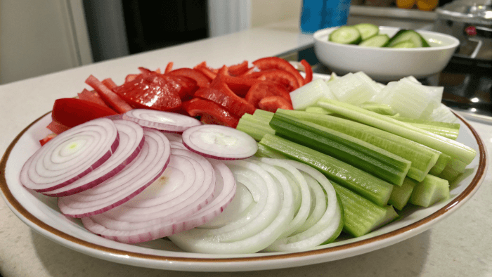 Adding fresh vegetables to tuna salad mixture