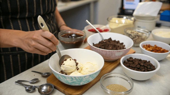 Milk, ice cream, and chocolate inside a blender before mixing