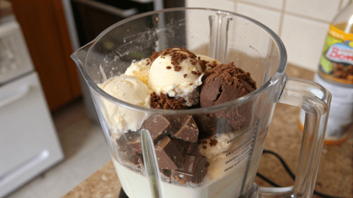 Blender mixing chocolate milkshake ingredients until creamy